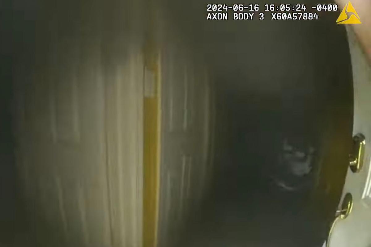 The officer enters the smoke-filled house, finds an older couple, and ushers the woman out, though the man said that he "can't walk." (Courtesy of Evesham Township Police)