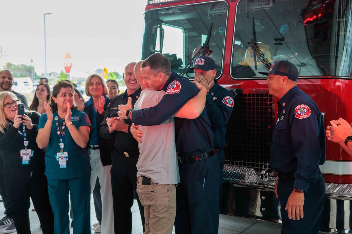 Mr. Willson hugs Mr. Estes, who helped orchestrate the surprise. (Courtesy of City of Hope Orange County)