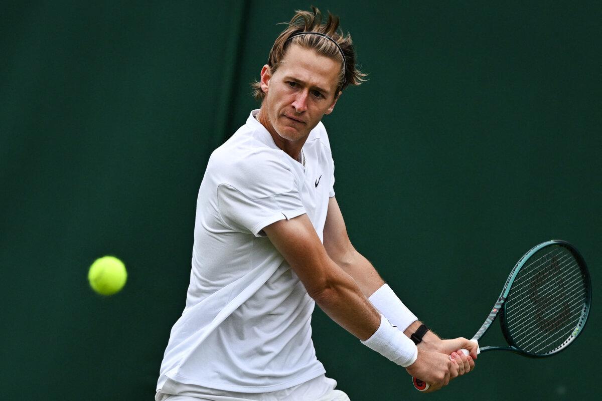 USA's Sebastian Korda returns the ball to France's Giovanni Mpetshi Perricard during their men's singles tennis match on the second day of the 2024 Wimbledon Championships at The All England Lawn Tennis and Croquet Club in Wimbledon, southwest London, on July 2, 2024. (Ben Stansall/AFP via Getty Images)
