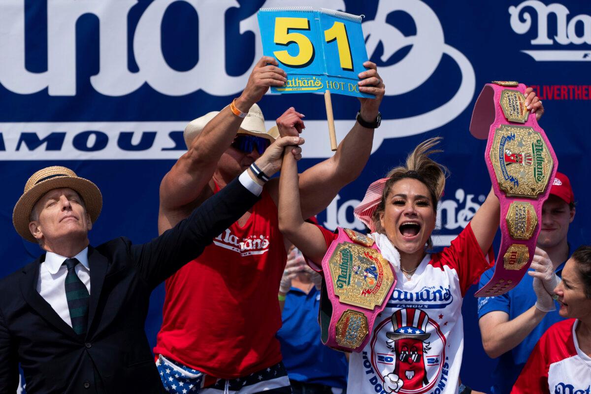 Miki Sudo (R) reacts after winning the women's division in the Nathan's Famous Fourth of July hot dog eating contest, at Coney Island in the Brooklyn borough of New York on July 4, 2024. (Julia Nikhinson/AP Photo)