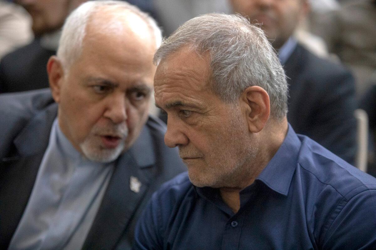 Iran's newly-elected President Masoud Pezeshkian is greeted by former foreign minister Mohammad Javad Zarif during a visit to the shrine of the Islamic Republic's founder Ayatollah Ruhollah Khomeini in Tehran, Iran, on July 6, 2024. (Majid Saeedi/Getty Images)