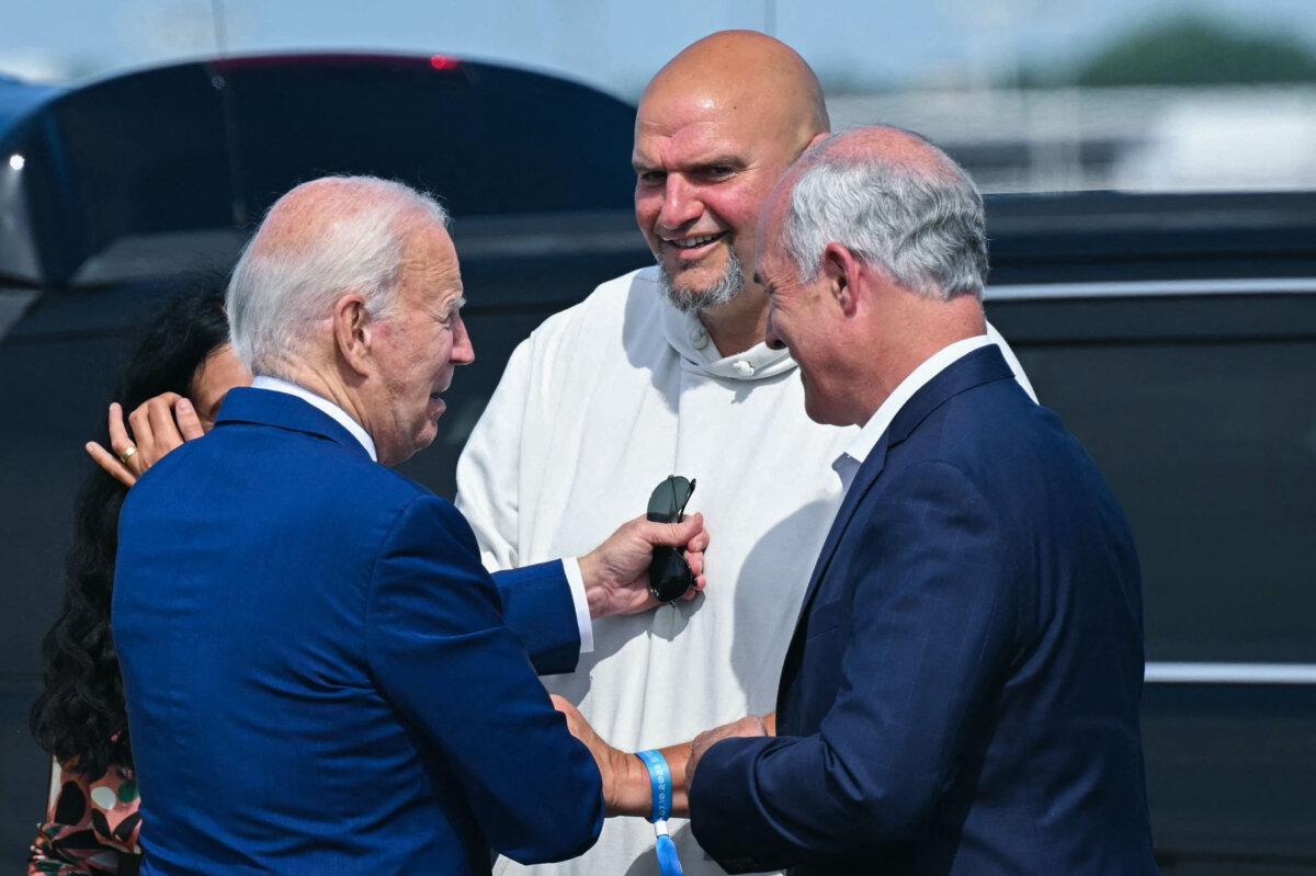 President Joe Biden is greeted by US Senators of Pennsylvania John Fetterman (C) and Bob Casey (R) at Philadelphia International Airport in Philadelphia, Pennsylvania, on July 7, 2024. (SAUL LOEB/AFP via Getty Images)