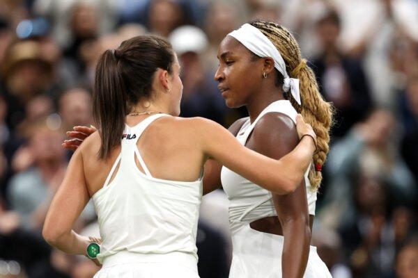 Emma Navarro of United States (L) embraces Coco Gauff of United States at the net following victory in the Ladies' Singles fourth round match during day seven of The Championships Wimbledon 2024 in London on July 7, 2024. (Clive Brunskill/Getty Images)