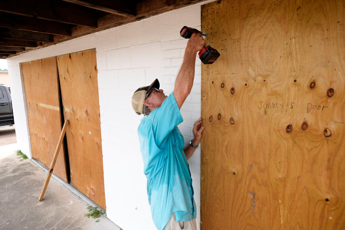Jimmy May boards windows as he prepares for Hurricane Beryl's arrival, in Port Lavaca, Texas, on July 7, 2024. (Eric Gay/AP Photo)