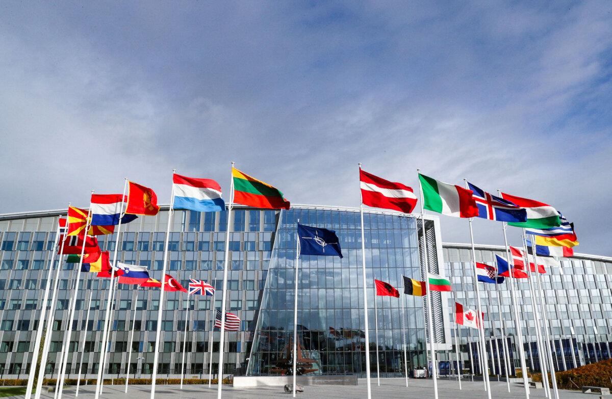 Flags wave outside NATO's headquarters ahead of a meeting of the alliance's defense ministers in Brussels on Oct. 21, 2021. (Pascal Rossignol/Reuters)