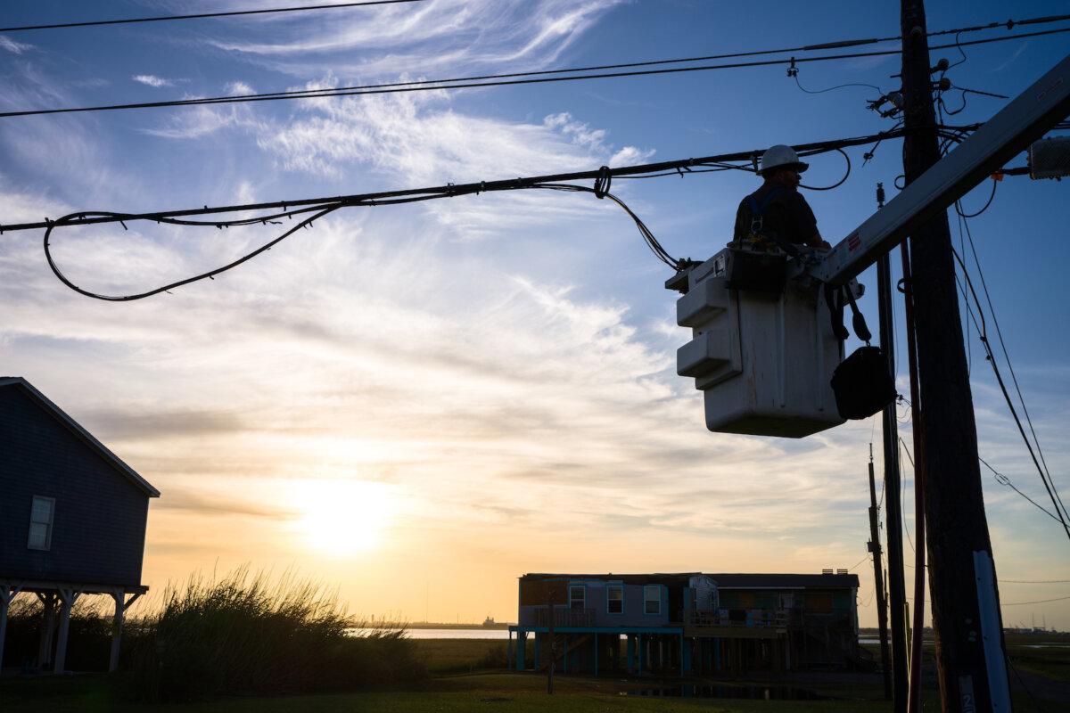 A utility worker works to restore a damaged powerline after Hurricane Beryl swept through Surfside, Texas, on July 08, 2024. (Brandon Bell/Getty Images)