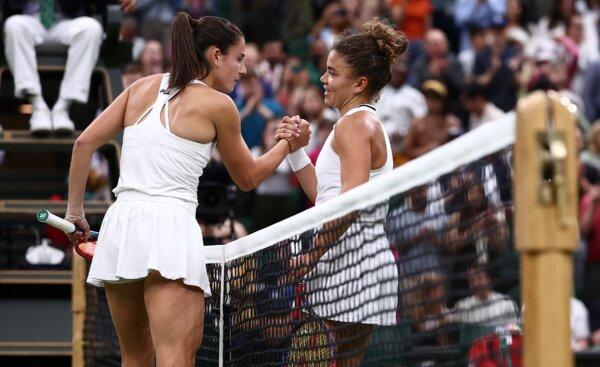 USA's Emma Navarro (L) shakes hands after losing against Italy's Jasmine Paolini during their women's singles quarter-finals tennis match at the 2024 Wimbledon Championships in London, on July 9, 2024. (Henry Nicholls/AFP)