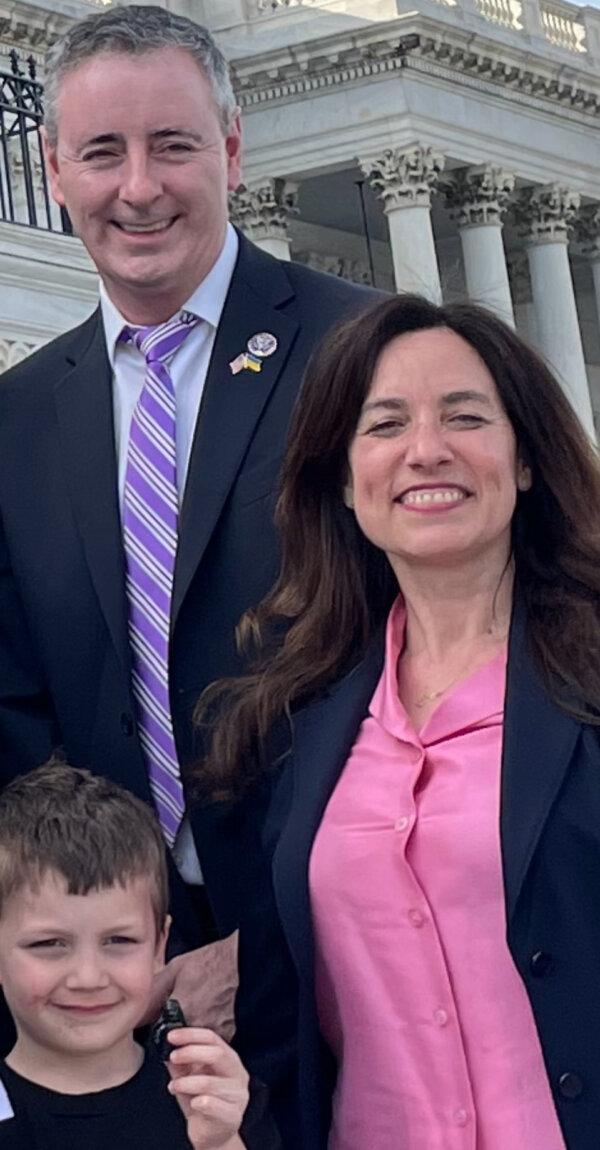 Policy manager at National Family Violence Law Center Danielle Pollack, Rep. Brian Fitzpatrick (R-Pa.), and Blake Sherlock, then age 5, on the steps of the U.S. Capitol after Kayden's Law was passed, on March 16, 2022. The bill is named after Tyler's older sister who was murdered by their father in a custody dispute (Photo by Heather Giglio)