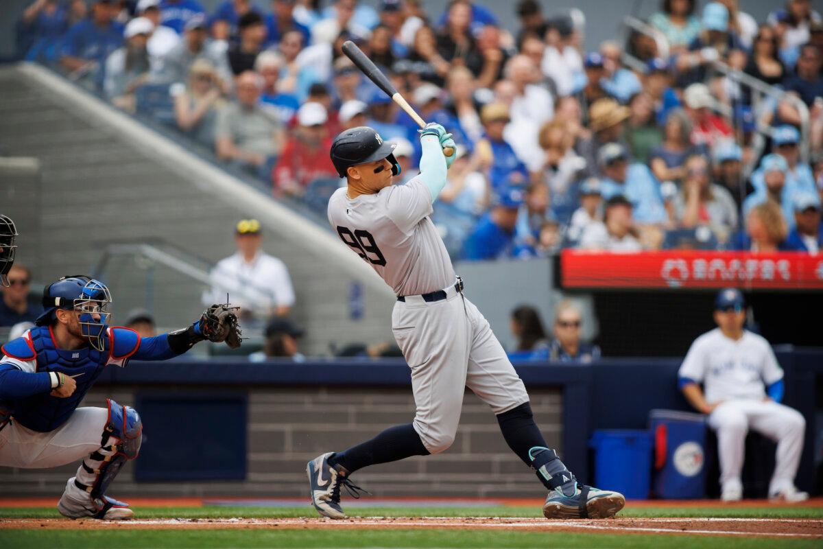 Aaron Judge #99 of the New York Yankees hits a two-run home run in the first inning of their MLB game against the Toronto Blue Jays at Rogers Centre in Toronto, Ontario, Canada on June 30, 2024. (Cole Burston/Getty Images)