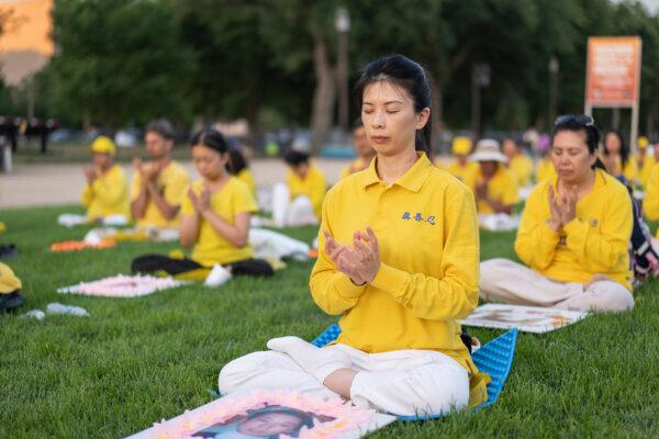 Falun Gong practitioners gather for a candlelight vigil commemorating Falun Gong practitioners’ persecution to death in China by the Chinese Communist Party at the National Mall in Washington on July 11, 2024. (Madalina Vasiliu/The Epoch Times)
