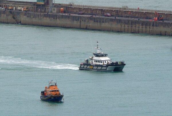 An RNLI Lifeboat and a Border Force vessel with groups of people thought to be illegal immigrants onboard, wait to unload in Dover, Kent, England, on July 9, 2024. (Gareth Fuller/PA Wire)