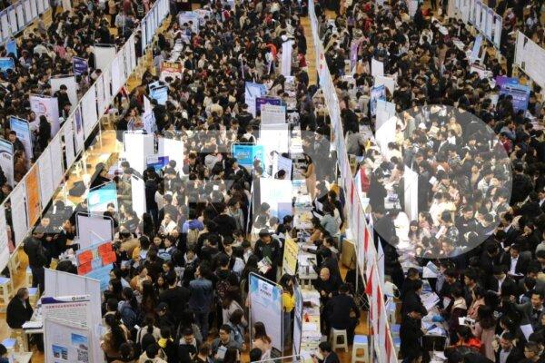 Chinese graduates crowd stalls to look for employment during a job fair at Zhengzhou University in Zhengzhou city, central China's Henan Province on March 22, 2019. (Zuo dongchen / Imaginechina)