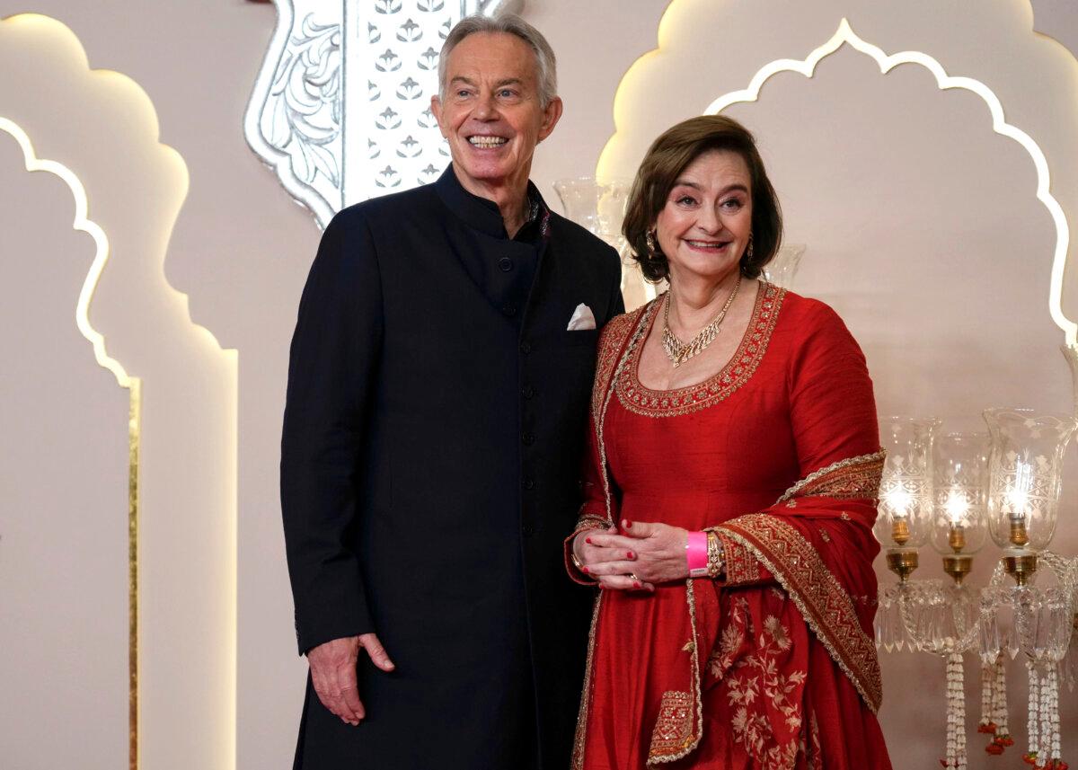 Former British Prime Minister Tony Blair poses for a photograph with his wife Cherie Blair at the wedding of bllionaire Mukesh Ambani's son Anant Ambani and Radhika Merchant at Jio World Convention Centre in Mumbai, India, on July 12, 2024. (Rajanish Kakade/AP Photo)