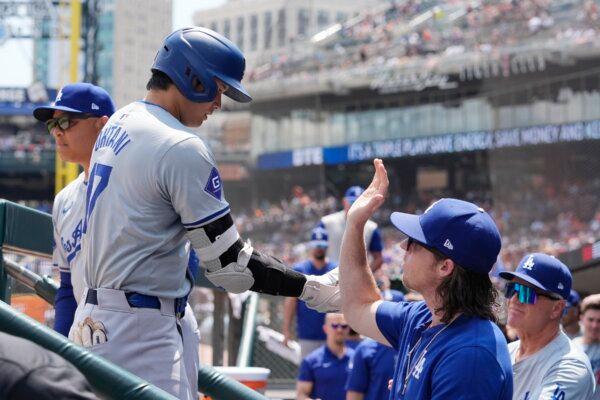 Los Angeles Dodgers designated hitter Shohei Ohtani is greeted in the dugout after a solo home run during the fifth inning of a baseball game against the Detroit Tigers in Detroit on July 13, 2024. (Carlos Osorio/AP Photo)