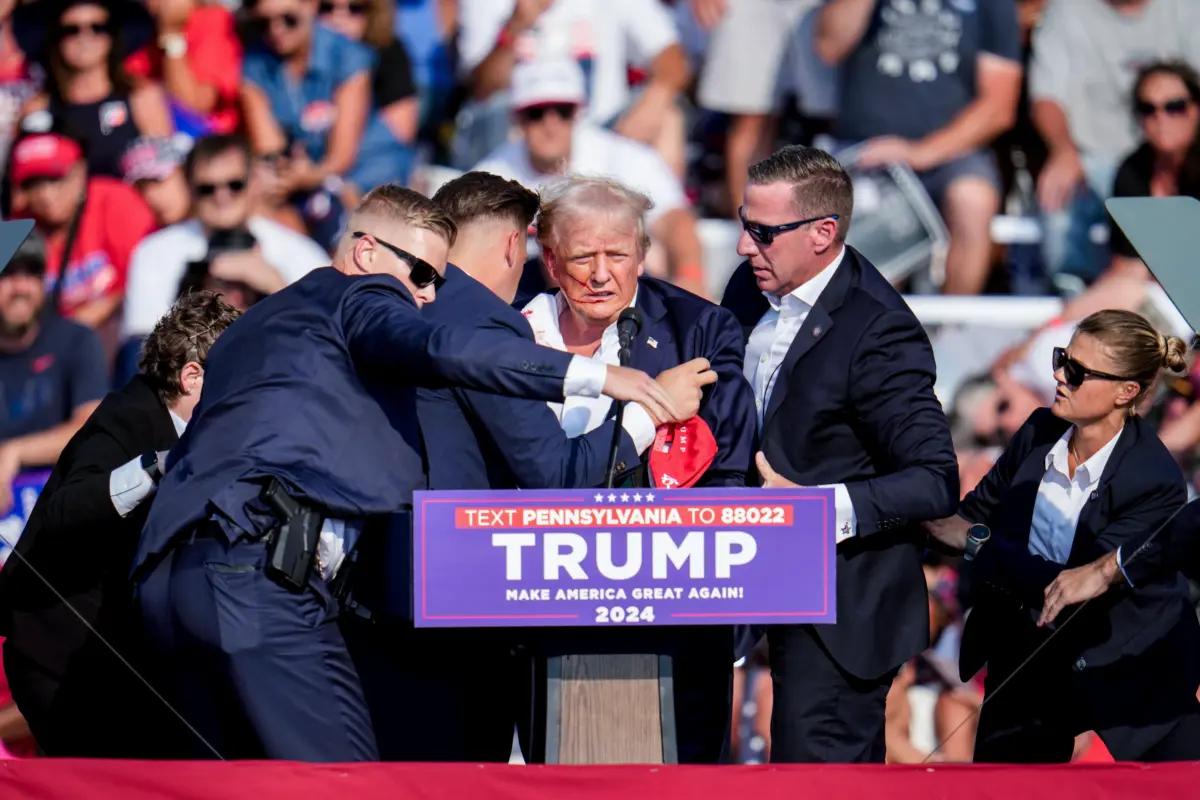 Republican presidential candidate former President Donald Trump is helped off the stage at a campaign event in Butler, Pa., on July 13, 2024. (Gene J. Puskar/AP Photo)