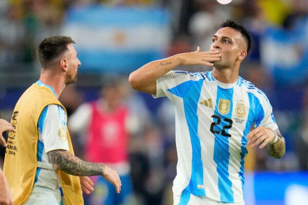 Argentina's Lautaro Martínez (22) celebrates with Lionel Messi after scoring his side's opening goal against Colombia during the Copa America final soccer match in Miami Gardens, Fla., on July 14, 2024. (Julio Cortez/AP Photo)