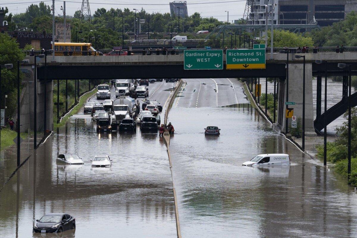 Cars are partially submerged in flood waters in the Don Valley following heavy rain in Toronto, on July 16 2024. (The Canadian Press/Arlyn McAdorey)