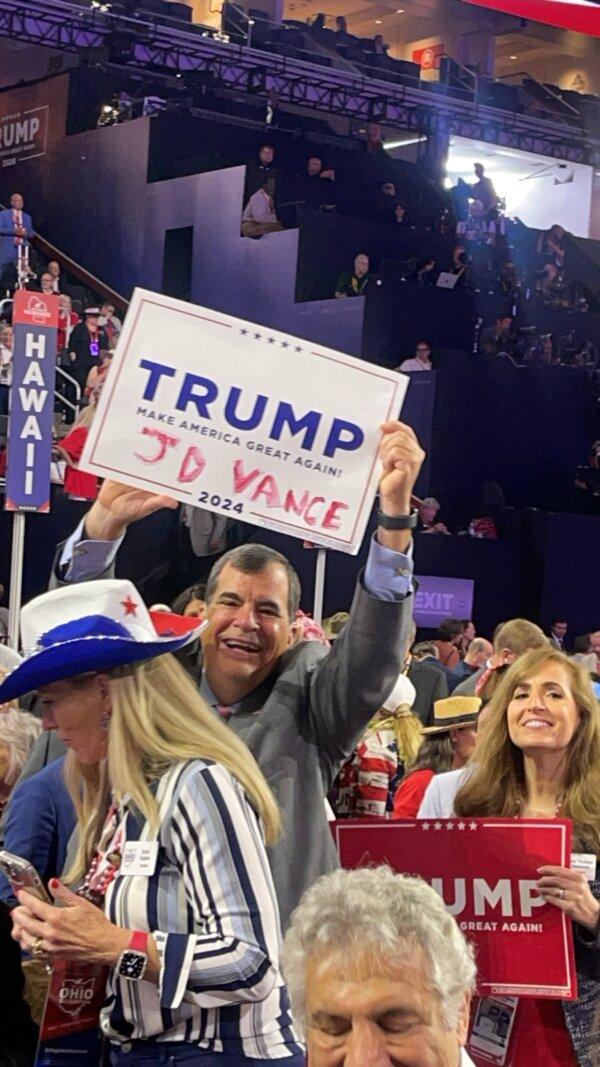 Ohio Sen. George Lang (L) holds up a makeshift sign, which his wife scrawled in lipstick to show support for vice presidential nominee JD Vance, currently serving as U.S. Senator from Ohio. (Courtesy of Debbie Lang)