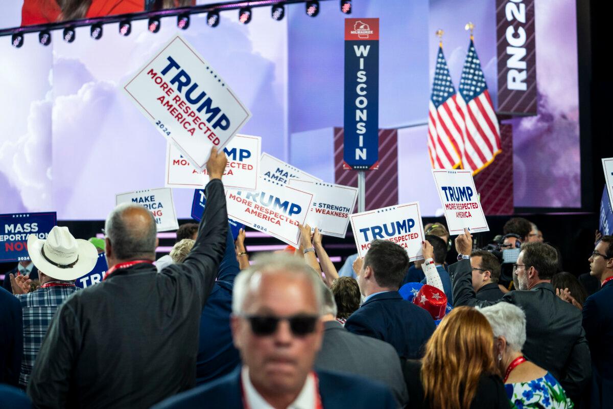 Delegates hold signs during the Republican National Convention (RNC) in Milwaukee, Wis., on July 17, 2024. (Madalina Vasiliu/The Epoch Times)