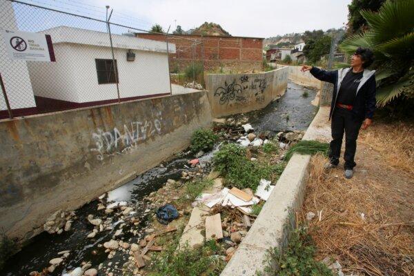 Environmentalist Margarita Diaz stands beside a channel of untreated water in the Los Laureles neighborhood, in Tijuana, Mexico, on July 3, 2024. (Jorge Duenes/Reuters)