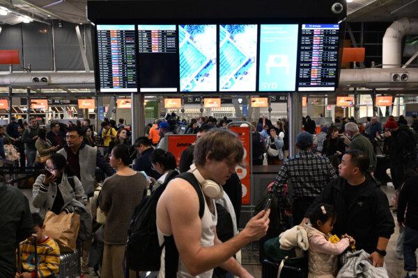 Travellers wait in long service lines at the Sydney domestic airport in Sydney, Australia, on July 19, 2024. (Saeed Khan/AFP via Getty Images)