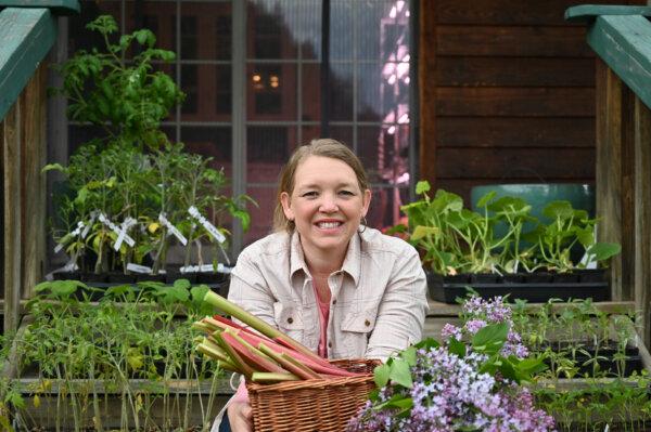 Ms. Thomas with her homegrown produce, which she cans to feed her family year-round. (Courtesy of Homesteading Family)