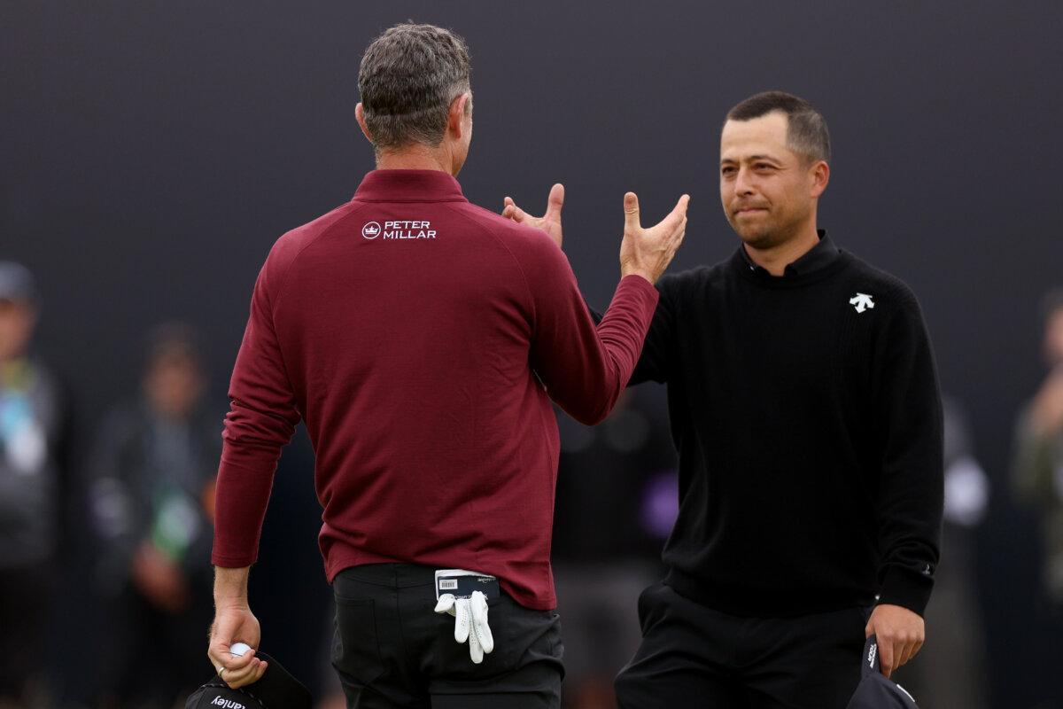 Xander Schauffele of the United States shakes hands with Justin Rose of England on the 18th green during Day 4 of the 152nd Open Championship at Royal Troon in Troon, Scotland, on July 21, 2024. (Harry How/Getty Images)