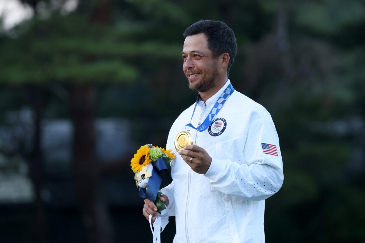 Xander Schauffele of Team United States celebrates with the gold medal during the medal ceremony after the final round of the Men's Individual Stroke Play on Day 9 of the Tokyo 2020 Olympic Games at Kasumigaseki Country Club in Kawagoe, Saitama, Japan, on August 1, 2021. (Chris Trotman/Getty Images)