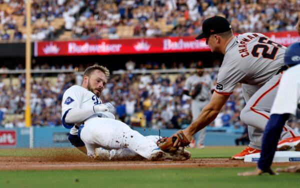 Gavin Lux (9) of the Los Angeles Dodgers is tagged out at third base trying to stretch a two-run double by Matt Chapman (26) of the San Francisco Giants in the first inning in Los Angeles on July 23, 2024. (Kevork Djansezian/Getty Images)