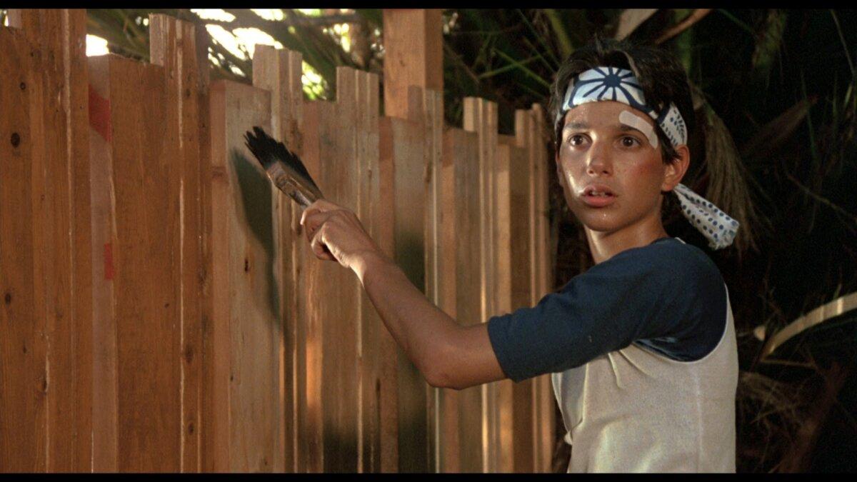 Daniel (Ralph Macchio) learns karate by painting a fence, in "The Karate Kid."(Columbia Pictures)