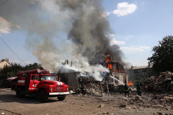 Rescuers put out a fire in a private house destroyed during a missile attack in Kostyatynivka, Donetsk region, on July 21, 2024. (Anatolii Stepanov / AFP via Getty Images)