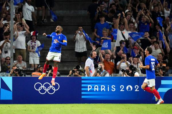 France's Alexandre Lacazette (L) celebrates after scoring his side's first goal during the men's Group A soccer match between France and the United States at the Velodrome stadium, during the 2024 Summer Olympics, in Marseille, France, on July 24, 2024. (Daniel Cole/AP Photo)