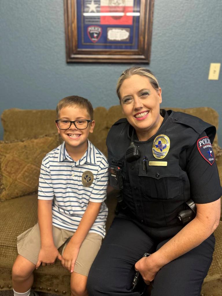 Lincoln with Officer Tammi Konvicka of Groesbeck Police Department, who was at the scene when the 9-year-old helped the elderly resident. (Courtesy of Randall Dobson)