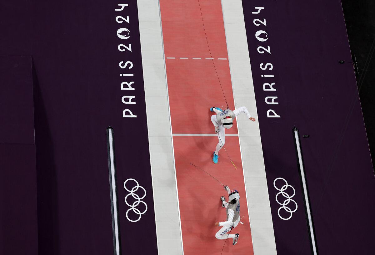 Lee Kiefer of Team United States (bottm) and Martyna Jelinska of Team Poland (top) compete in the Fencing Women's Foil Individual Table of 32 on day two of the Olympic Games Paris 2024 at Grand Palais in Paris on July 28, 2024. (Rob Carr/Getty Images)