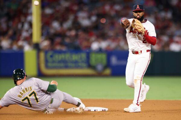 Los Angeles Angels third baseman Luis Rengifo (2) throws to first base to complete a double play as Oakland Athletics' Brett Harris (77) slides into second base during seventh inning of a baseball game in Anaheim, Calif., on July 27, 2024. (Jessie Alcheh/AP Photo)