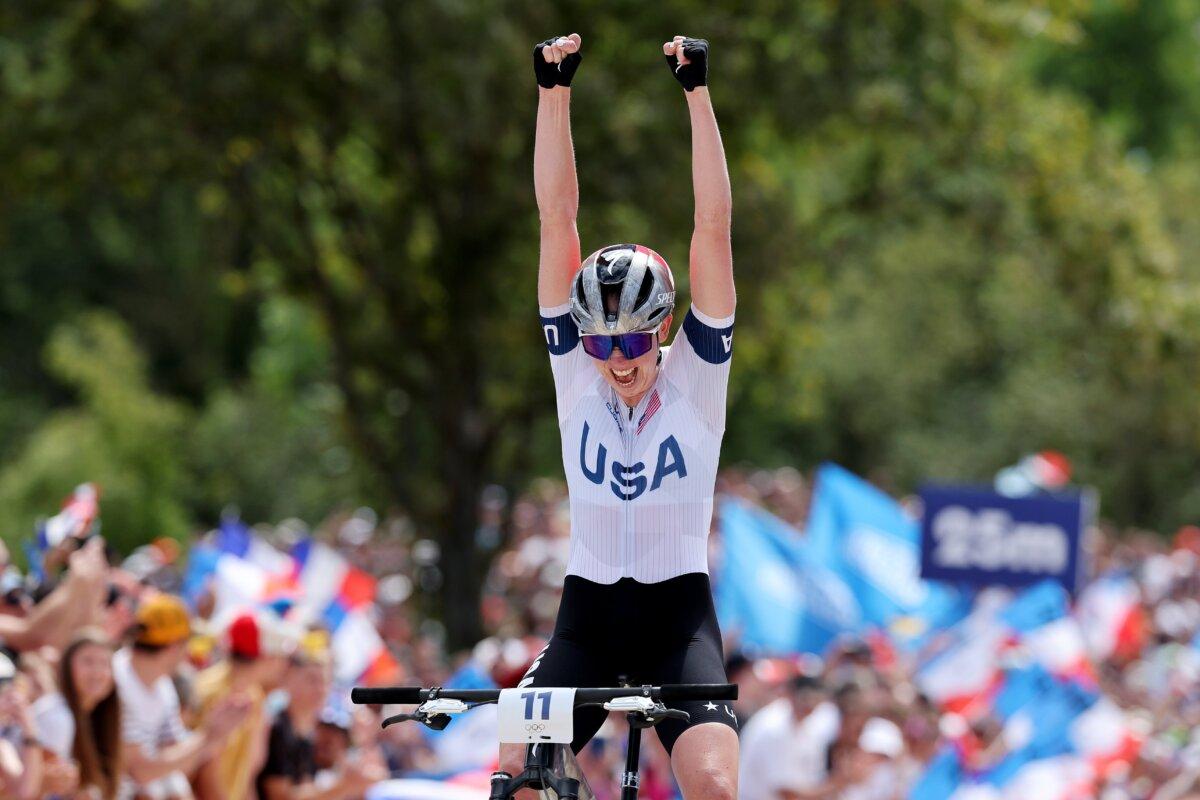 Haley Batten of Team United States celebrates winning silver as she crosses the finish line during the Women’s Cross-Country Cycling Mountain Bike Gold Medal race on day two of the Olympic Games Paris 2024 at Elancourt Hill in Elancourt, France, on July 28, 2024. (Tim de Waele/Getty Images)