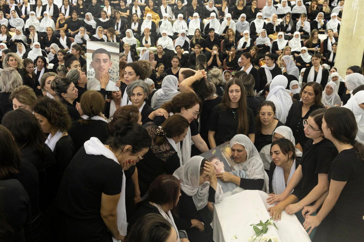 Israel Vows Retaliation on Hezbollah After Rocket Attack Kills 12 on Soccer Field 2 Mourners attend a funeral for 10 of the victims of the previous day's rocket attack, in Majdal Shams, Israel, on July 28, 2024. (Amir Levy/Getty Images)