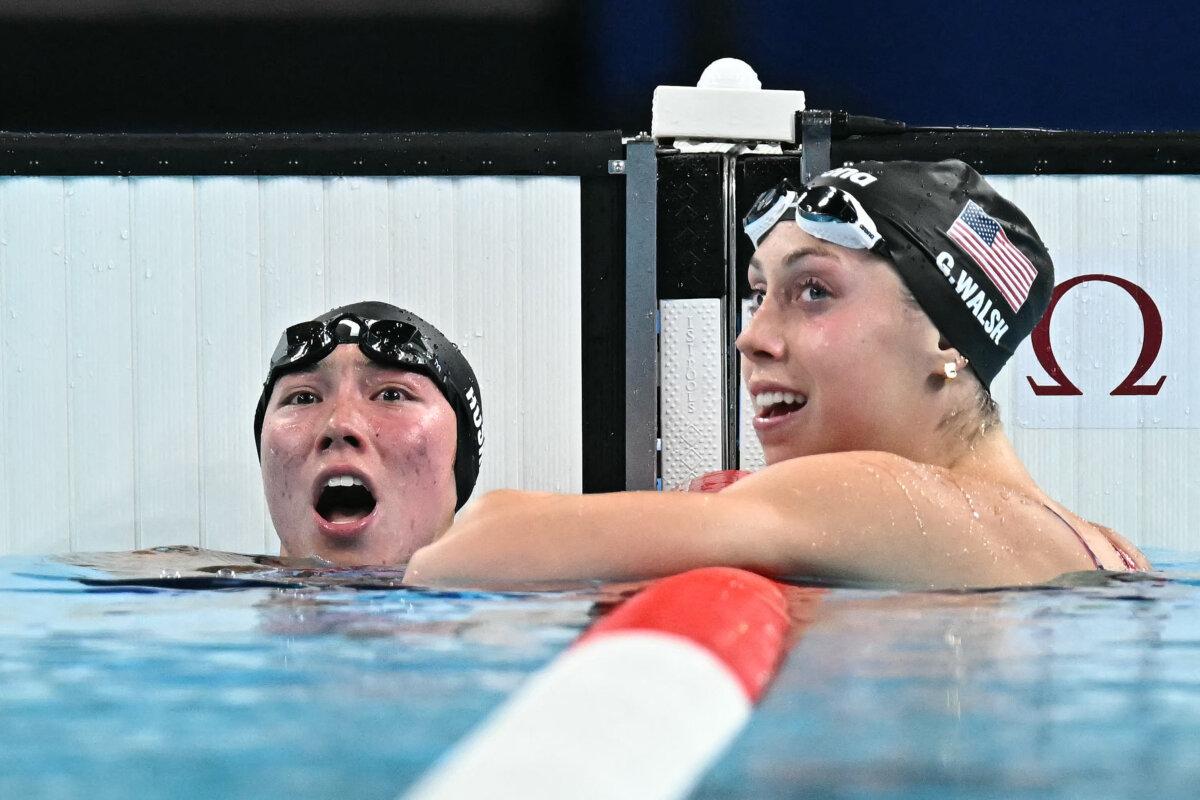 Team USA's Torri Huske (L) celebrates with Gretchen Walsh after winning the final of the women's 100m butterfly swimming event during the Paris 2024 Olympic Games at the Paris La Defense Arena in Nanterre, west of Paris, on July 28, 2024. (Manan Vatsyayana/AFP via Getty Images)