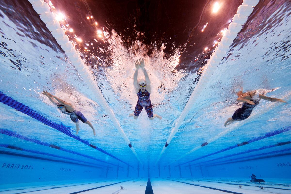 Reona Aoki of Team Japan, Lilly King of Team United States, and Angharad Evans of Team Great Britain compete in the Women's 100m Breaststroke Heats on day two of the Olympic Games Paris 2024 at Paris La Defense Arena in Nanterre, France, on July 28, 2024 . (Adam Pretty/Getty Images)