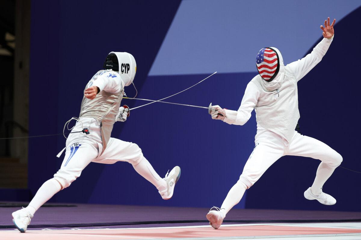 Alex Tofalides of Team Cyprus (L) and Nick Itkin of Team United States (R) compete in the Fencing Men's Foil Individual Table of 32 on day three of the Olympic Games Paris 2024 at Grand Palais in Paris on July 29, 2024. (Al Bello/Getty Images)