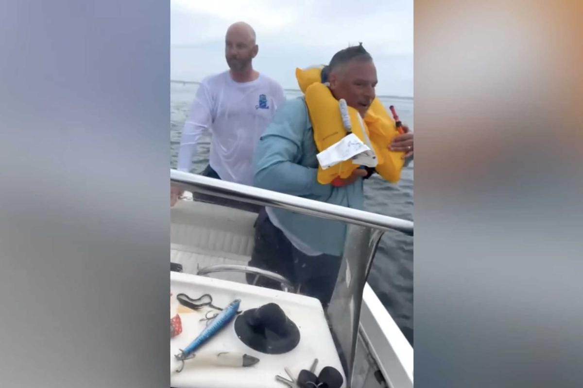 The two men were found to be happy and smiling after being pulled aboard the brothers' boat. (Screenshot/Newsflare)