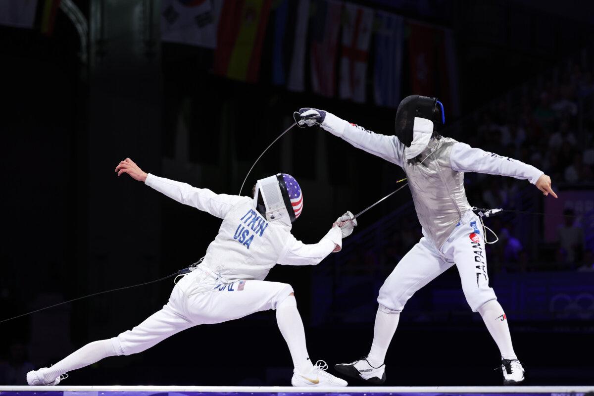 Kazuki Iimura of Japan (R) and Nick Itkin of United States compete in the Fencing Men's Foil Individual Bronze Medal Bout on day three of the Olympic Games Paris 2024 at Grand Palais in Paris on July 29, 2024. (Al Bello/Getty Images)