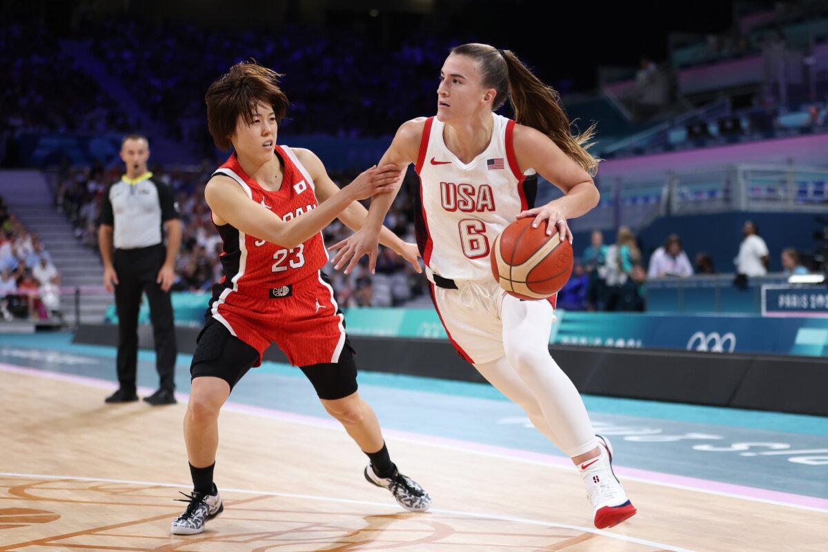 Sabrina Ionescu #6 of Team United States drives past Mai Yamamoto #23 of Team Japan during the Women's Group Phase - Group C game between Japan and United States on day three of the Olympic Games Paris 2024 at Stade Pierre Mauroy in Lille, France on July 29, 2024. (Gregory Shamus/Getty Images)