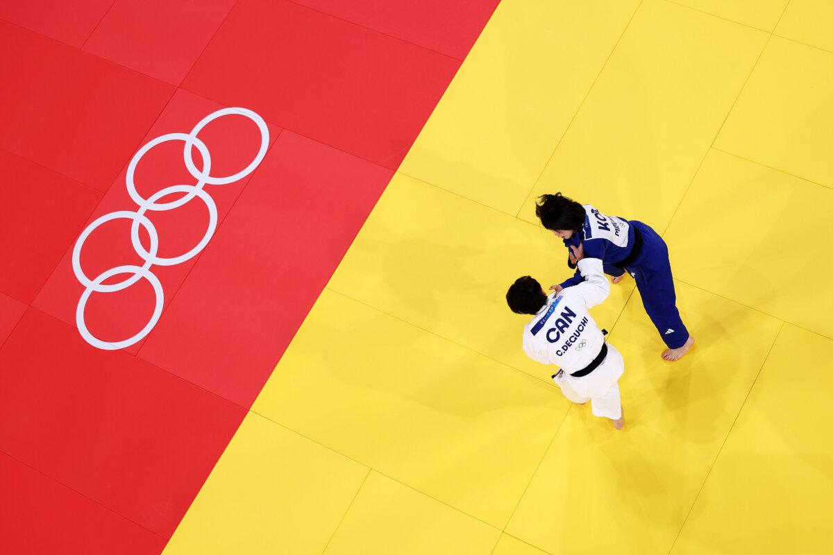 Christa Deguchi (White) of Team Canada and Mimi Huh (Blue) of Team Republic of Korea compete during the Judo Women’s -57 kg Final contest on day three of the Olympic Games Paris 2024 at Champs-de-Mars Arena in Paris on July 29, 2024. (Rob Carr/Getty Images)
