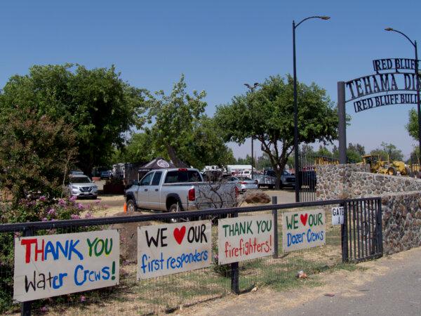 Signs supporting first responders and fire crews line the entrance to the Cal Fire incident base in Red Bluff, Calif., on July 29, 2024. (Travis Gillmore/The Epoch Times)