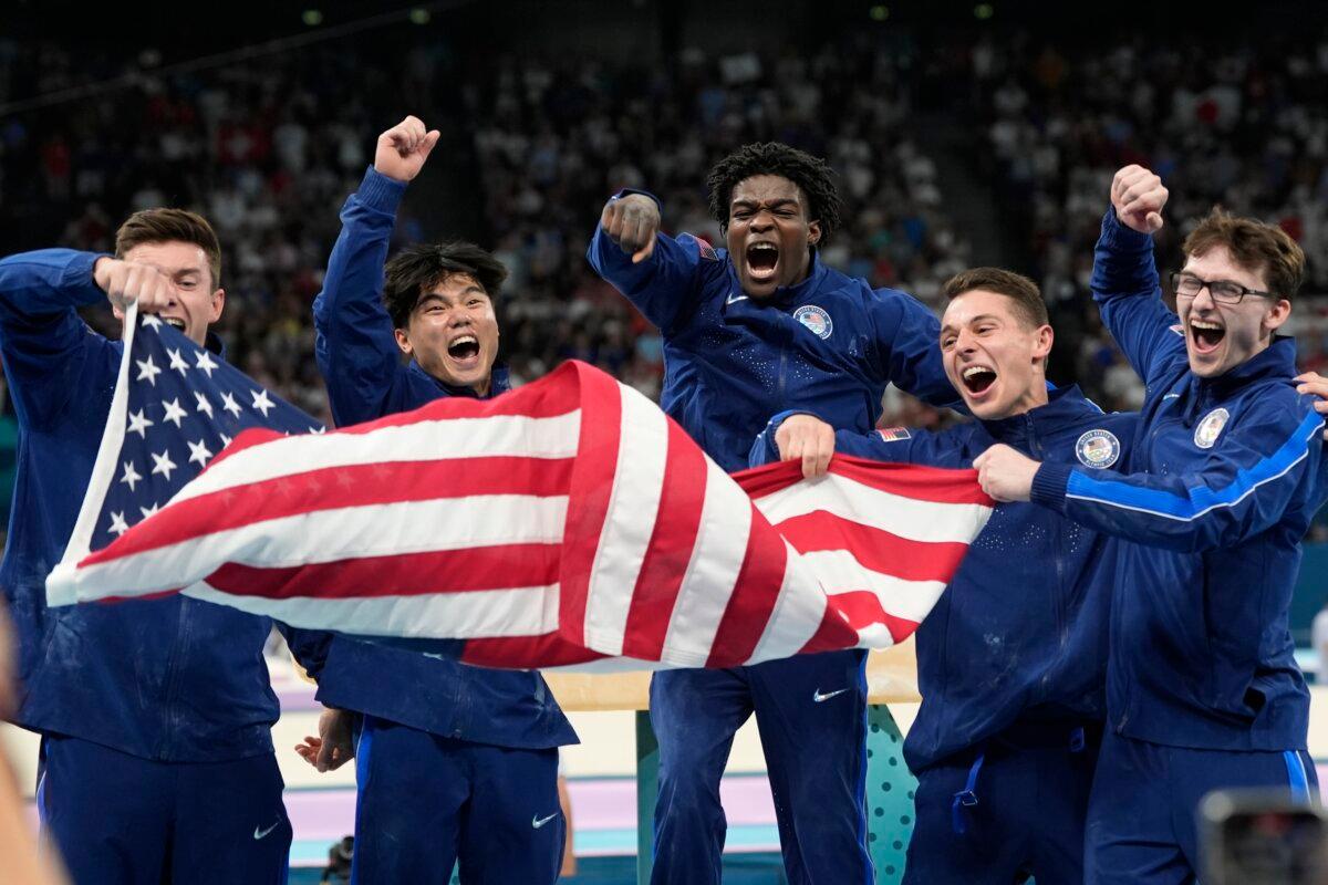 (L–R) Team USA Brody Malone, Asher Hong, Fred Richard, Paul Juda, and Stephen Nedoroscik celebrate their bronze medal during the men's artistic gymnastics team finals round at Bercy Arena at the 2024 Summer Olympics in Paris, France, on July 29, 2024. (Abbie Parr/AP Photo)