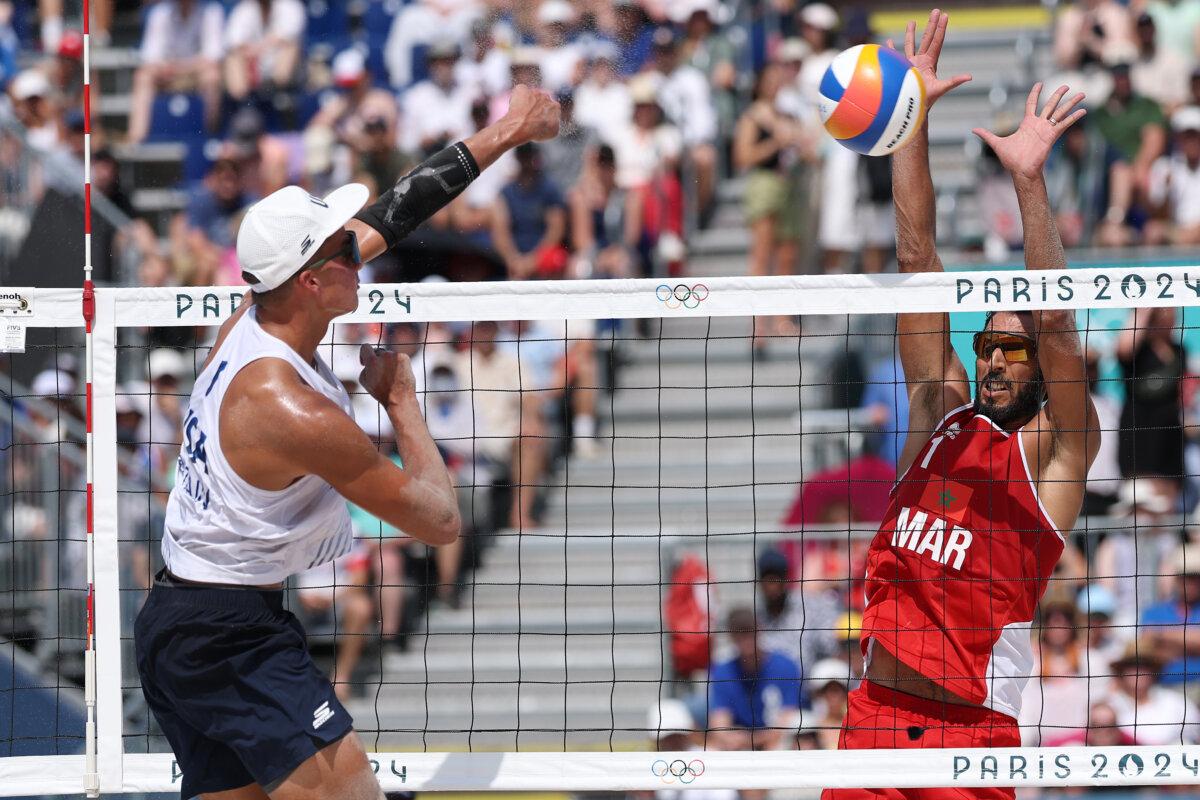 Miles Partain of Team United States attacks the net against a block attempt by Mohammed Abicha of Team Morocco during the Men's Preliminary Phase - Pool D match on day four of the Olympic Games Paris 2024 at Eiffel Tower Stadium in Paris on July 30, 2024. (Lintao Zhang/Getty Images)