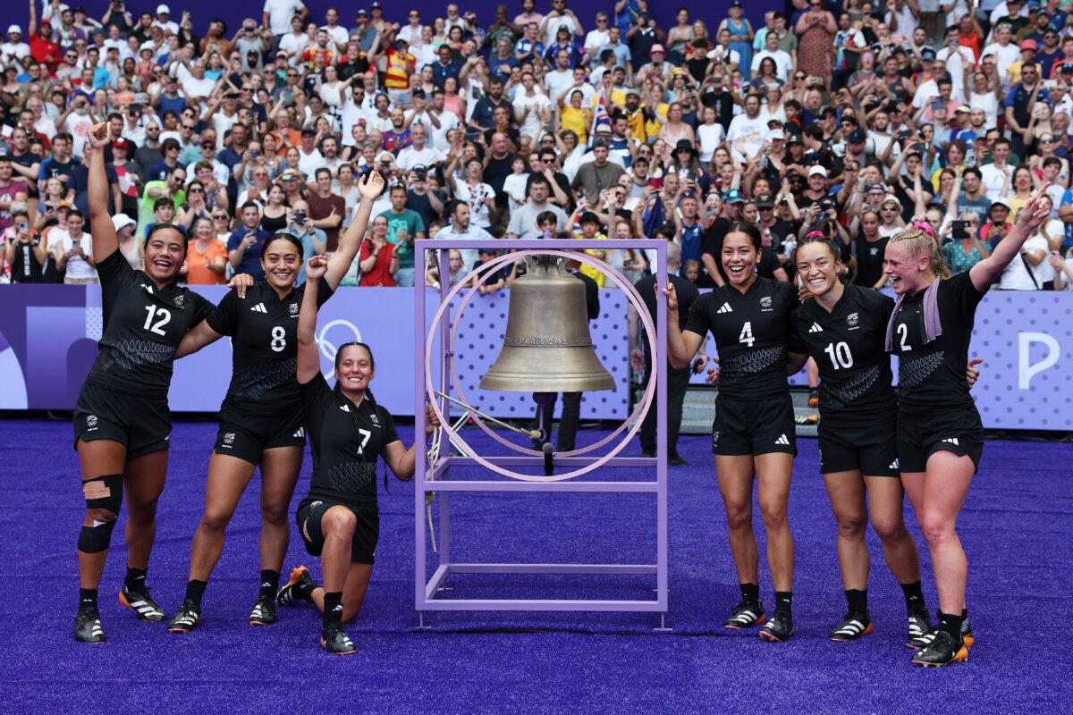 Players of Team New Zealand pose for a photo with the victory bell following victory in the Women's Rugby Sevens Semifinal match between Team New Zealand and Team United States on day four of the Olympic Games Paris 2024 at Stade de France in Paris on July 30, 2024. (Cameron Spencer/Getty Images)