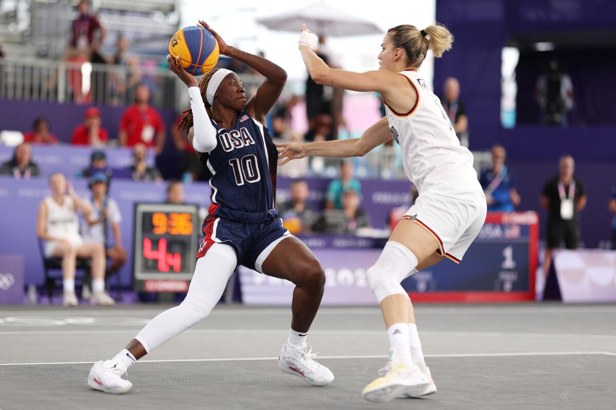 Rhyne Howard #10 of Team United States looks to pass against Sonja Greinacher #14 of Team Germany during a Women's Pool Round on day four of the Olympic Games Paris 2024 at Esplanade Des Invalides in Paris on July 30, 2024. (Lars Baron/Getty Images)