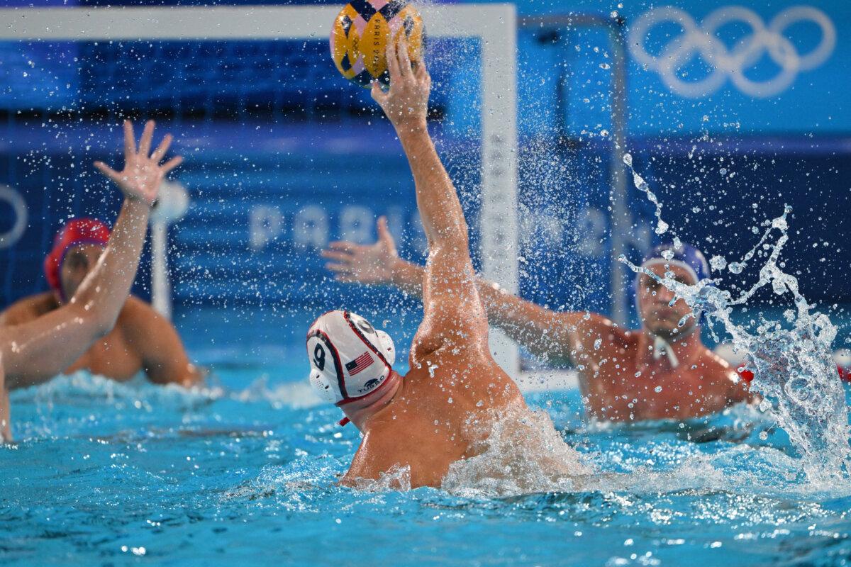 US' #09 Alex Bowen (C) shoots the ball in the men's water polo preliminary round group A match between USA and Romania during the Paris 2024 Olympic Games at the Aquatics Centre in Saint-Denis, north of Paris, on July 30, 2024. (Andreas Solaro /AFP via Getty Images)